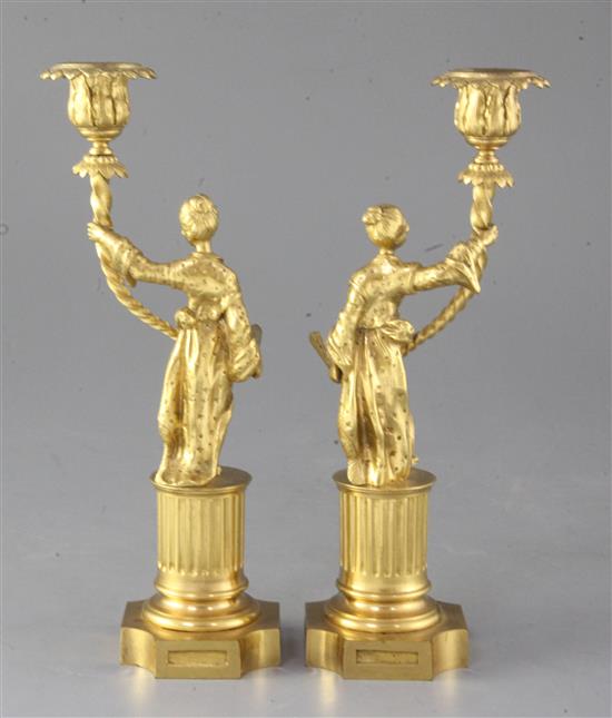 A pair of Regency gilt brass chinoiserie candlesticks, height 9.25in.